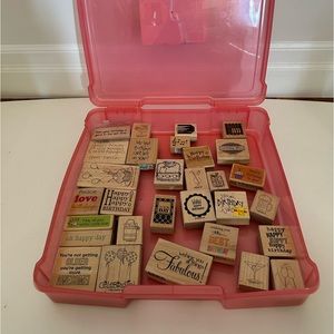Pink plastic scrapbook paper box with 32 rubber and wood stamps inside
